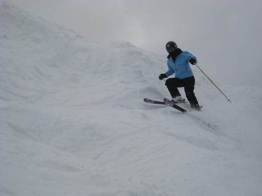 Skier on a steep ski slope at a CO ski area